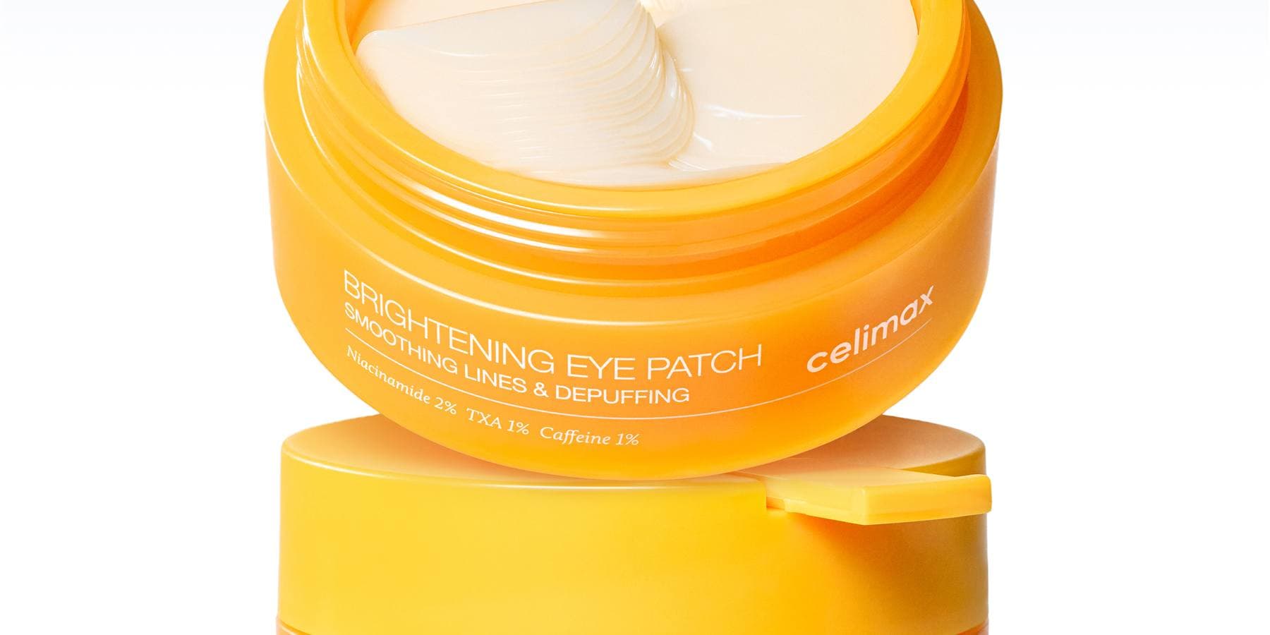 celimax TXA Brightening Eye Patch — an open amber jar showing the patches, labelled Niacinamide 2%, TXA 1%, Caffeine 1%