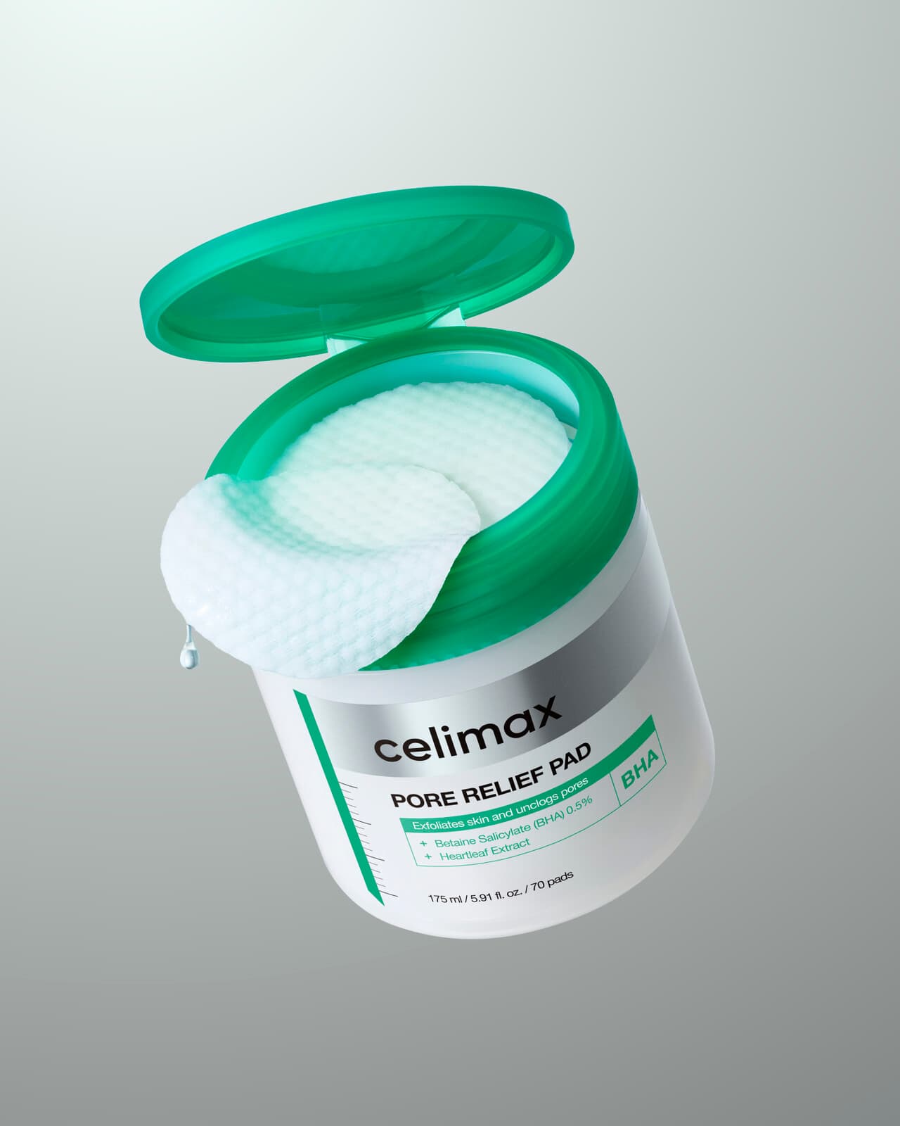 celimax Pore Relief Pad — an open jar with a green lid, a textured pad lifted out, label reading BHA, Betaine Salicylate 0.5% and Heartleaf Extract